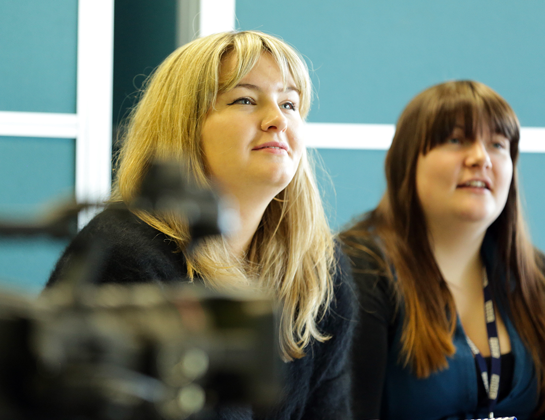 Two students in a filming workshop